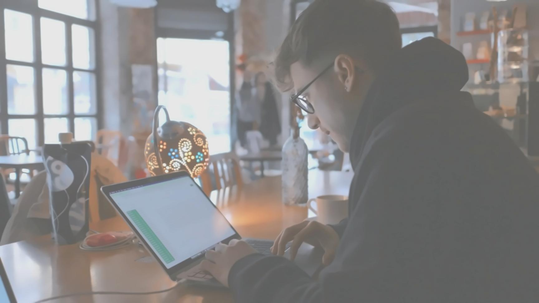 Student working on budget analysis with laptop